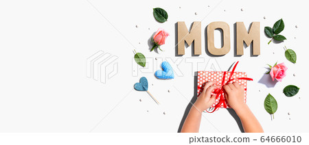 Little boy making a gift box for his mother Little boy making a gift box for his mother 64666010