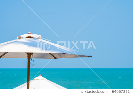 White umbrella around beautiful tropican nature of beach sea ocean White umbrella around beautiful tropican nature of beach sea ocean 64667251