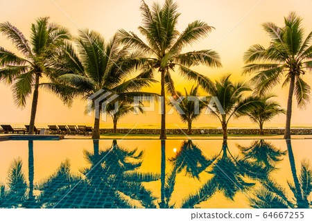 Beautiful nature with palm tree around outdoor swimming pool in hotel resort nearly sea ocean beach 64667255