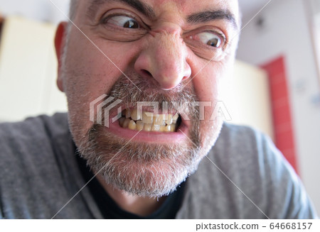 Portrait of an extremely angry middle-aged 64668157