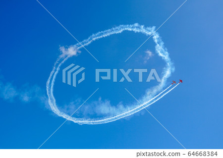 Plane doing acrobatic formation in the blue sky. Airplanes on airshow 64668384