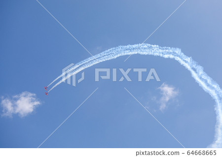 Plane doing acrobatic formation in the blue sky. Airplanes on airshow 64668665