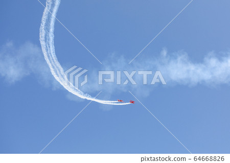 Plane doing acrobatic formation in the blue sky. Airplanes on airshow 64668826