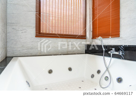 White bathtub and Jacuzzi decoration interior of bathroom 64669117