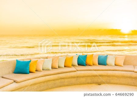Comfortable pillow on sofa chair around outdoor patio with sea ocean beach view Comfortable pillow on sofa chair around outdoor patio with sea ocean beach view 64669290