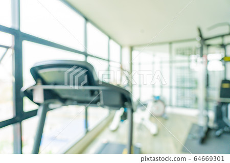 Abstract blur fitness equipment in gym room interior 64669301