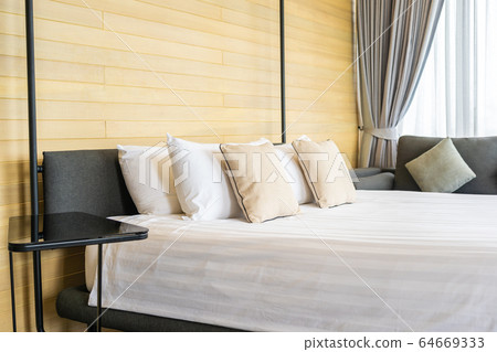 White comfortable pillow on bed decoration interior of bed room White comfortable pillow on bed decoration interior of bed room 64669333