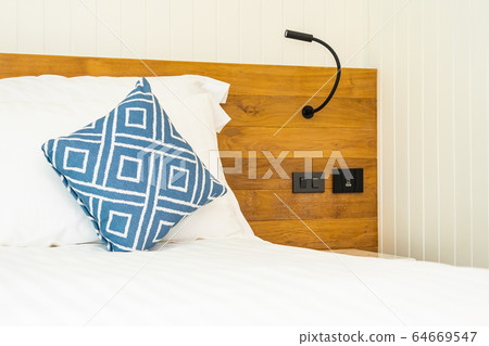 Comfortable white pillow on bed decoration in bedroom Comfortable white pillow on bed decoration in bedroom 64669547