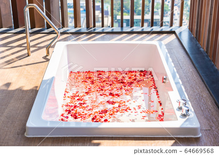 Red rose flower on water in bathtub decoration interior Red rose flower on water in bathtub decoration interior 64669568