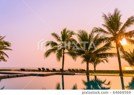 Beautiful nature with palm tree around outdoor swimming pool in hotel resort nearly sea ocean beach Beautiful nature with palm tree around outdoor swimming pool in hotel resort nearly sea ocean beach 64669569