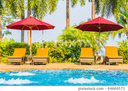 Portrait beautiful young asian woman relax around swimming pool in hotel resort 64669571