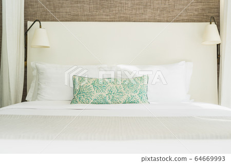 White comfortable pillow on bed decoration interior White comfortable pillow on bed decoration interior 64669993