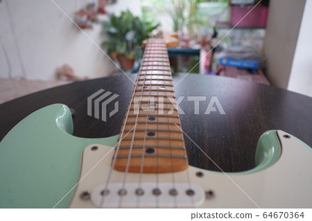 Green electric guitar See parts of the guitar Green electric guitar See parts of the guitar 64670364
