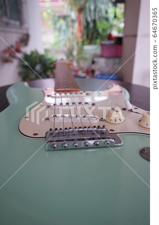 Green electric guitar See parts of the guitar Green electric guitar See parts of the guitar 64670365