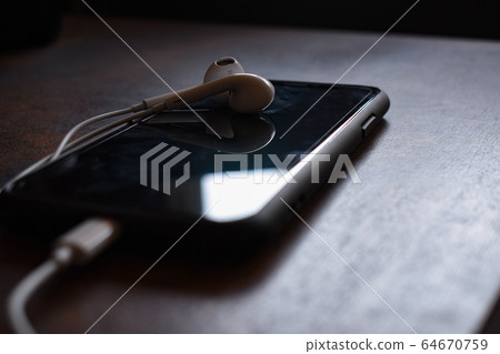 Smartphone and earphones Smartphone and earphones 64670759