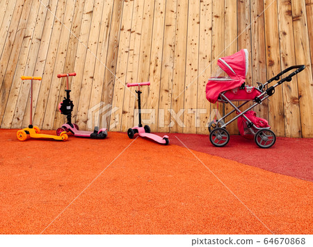 three scooters and a stroller in the playground for the game three scooters and a stroller in the playground for the game 64670868