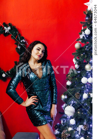 Beautiful brunette woman at Christmas tree new year holiday gifts Beautiful brunette woman at Christmas tree new year holiday gifts 64673044