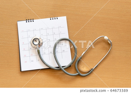 stethoscope and calendar on wooden table, schedule stethoscope and calendar on wooden table, schedule 64673389
