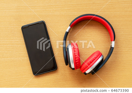 Headphones and alarm clock and smartphone on Headphones and alarm clock and smartphone on 64673390