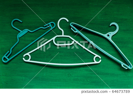 many hangers for clothes on the background many hangers for clothes on the background 64673789