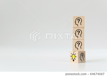 Wooden cube block flip over with head human symbol and light bulb icon Wooden cube block flip over with head human symbol and light bulb icon 64674087
