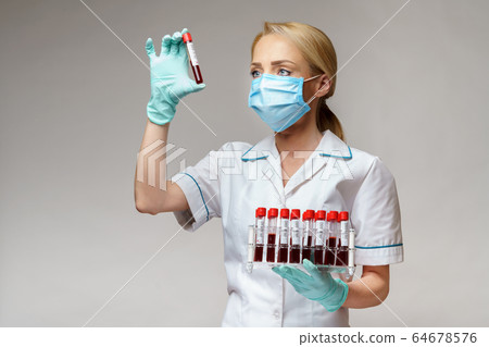 medical doctor nurse woman wearing protective mask and gloves - holding rack with virus blood tests 64678576