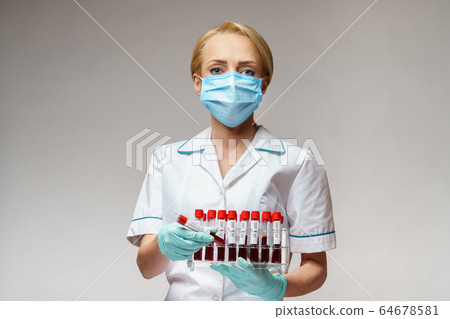 medical doctor nurse woman wearing protective mask and gloves - holding rack with virus blood tests 64678581