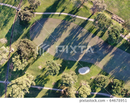 Aerial view of golf course with green field in the valley. 64678951