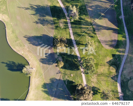 Aerial top view of golf course with green field Aerial top view of golf course with green field 64679237