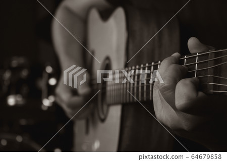 Guitar Player Playing Acoustic Guitar 64679858