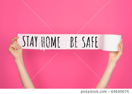 Stay home lettering on white toilet paper. 64680074