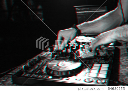 hands on DJ playing music on professional mixer controller in nightclub hands on DJ playing music on professional mixer controller in nightclub 64680255
