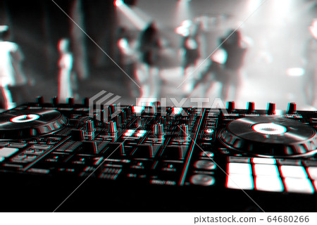 professional DJ mixer controller at a concert in a nightclub professional DJ mixer controller at a concert in a nightclub 64680266