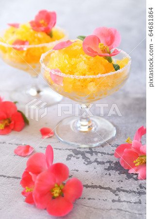 Orange granita, frozen summer dessert in two glasses, blooming japanese quince dressing 64681864