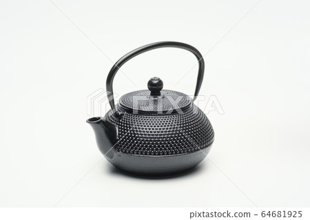 Black cast iron teapot on a white background. Black cast iron teapot on a white background. 64681925
