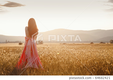 girl dancing in a field in a beautiful pink dress - Stock Photo ...