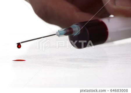Macro view of drop of blood from syringe 64683008