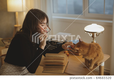 Woman Reading Book at Home 64683320