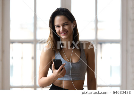 Female listening music take a break during workout 64683488
