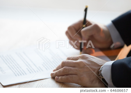 Close up view of male hand signing business contract concept 64686657