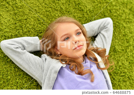 Portrait of beautiful teen girl lying on floor Portrait of beautiful teen girl lying on floor 64688875