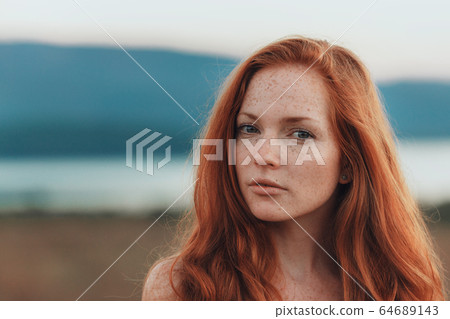 Incredible young woman with long curly hair and 64689143