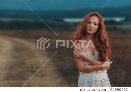 Incredible young woman with long curly hair and 64690462