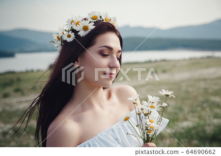 Beautiful brunette woman is enjoying spring in a Beautiful brunette woman is enjoying spring in a 64690662