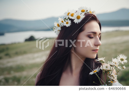 Beautiful brunette woman is enjoying spring in a Beautiful brunette woman is enjoying spring in a 64690666