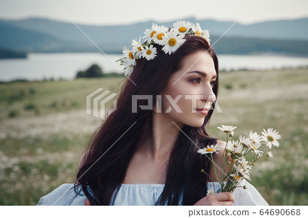 Beautiful brunette woman is enjoying spring in a 64690668