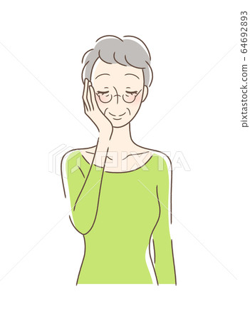 一個女人撫摸她的手掌與她的臉頰 一個女人撫摸她的手掌與她的臉頰 64692893