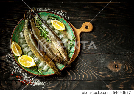 Raw fish pike with herbs and spices 64693637