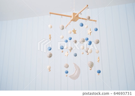 Baby crib mobile. Toys above the baby crib. Hanging soft balls for the child. 64693731