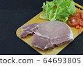 Pork put on a wooden cutting board with lettuce Carrots and tomatoes. Selective focus 64693805